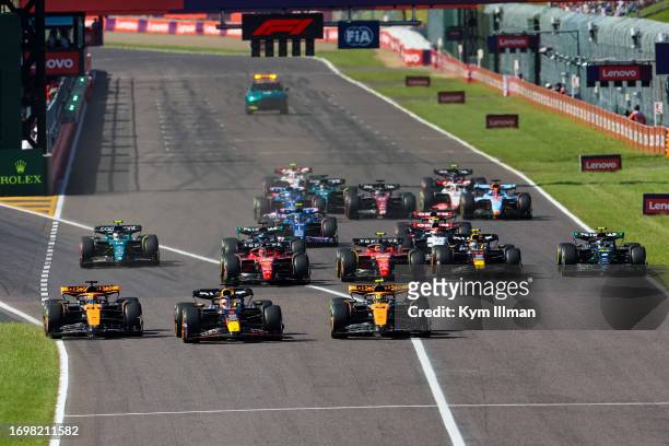 Max Verstappen of the Netherlands and Oracle Red Bull Racing battles with Oscar Piastri of Australia and McLaren F1 and Lando Norris of Great Britain...