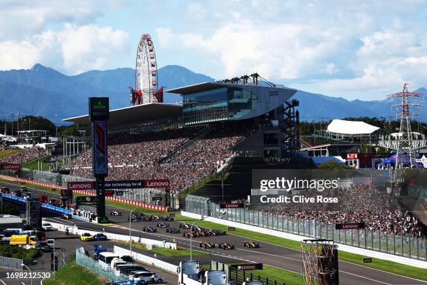 Max Verstappen of the Netherlands driving the Oracle Red Bull Racing RB19 competes for the lead with Oscar Piastri of Australia driving the McLaren...