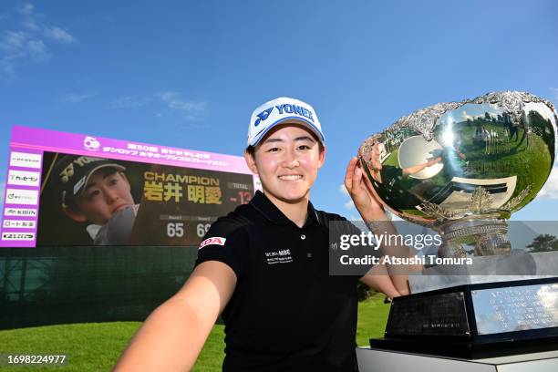 Akie Iwai of Japan imitates the selfie after winning the tournament following the final round of 50th Miyagi TV Cup Dunlop Ladies Open Golf...