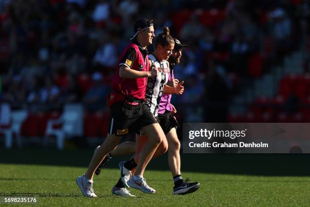 Brianna Davey of the Magpies is helped from the field during the round four AFLW match between St Kilda Saints and Collingwood Magpies at RSEA Park,...