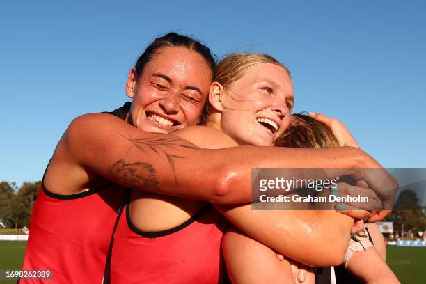 Jesse Wardlaw and Serene Watson embrace their teammates following victory in the round four AFLW match between St Kilda Saints and Collingwood...