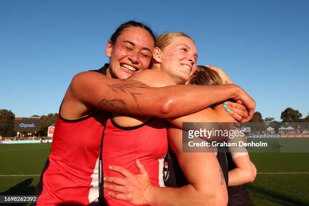 Jesse Wardlaw and Serene Watson embrace their teammates following victory in the round four AFLW match between St Kilda Saints and Collingwood...