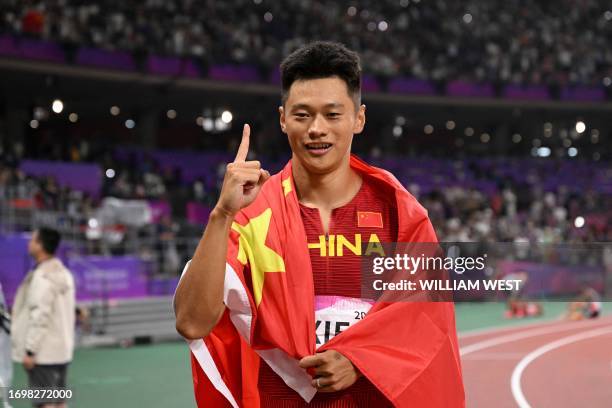 China's Xie Zhenye celebrates winning the men's 100m final athletics event during the 2022 Asian Games in Hangzhou in China's eastern Zhejiang...