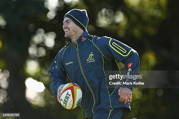 Berrick Barnes laughs as he runs the ball during a Wallabies training session at St Josephs College on June 3, 2013 in Sydney, Australia.