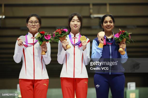 Silver medalist Han Jiayu of Team China, gold medalist Huang Yuting of Team China and bronze medalist Ramita of Team India pose during the medal...