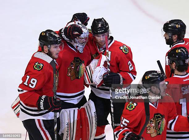 Jonathan Toews, goaltender Corey Crawford and Duncan Keith of the Chicago Blackhawks celebrate with teammates their 4-2 win over the Los Angeles...