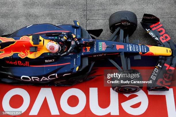 Race winner Max Verstappen of the Netherlands and Oracle Red Bull Racing climbs out of his car in parc ferme during the F1 Grand Prix of Japan at...