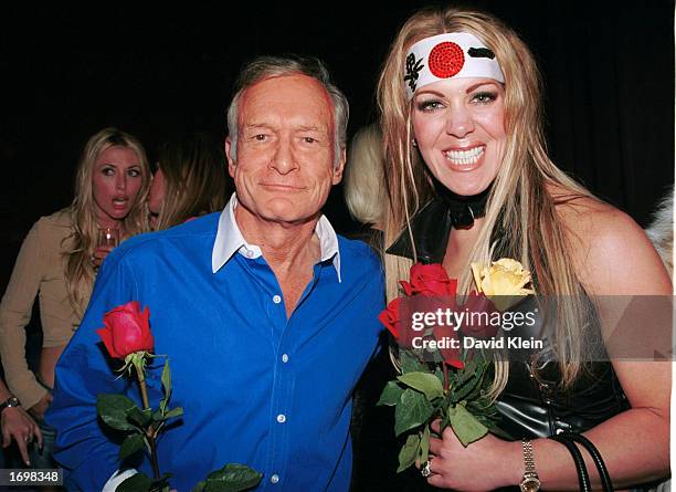 Playboy founder Hugh Hefner poses with former wrestler, Joanie Laurer, during Barfly 5th year anniversary party on December 18, 2002 in West...