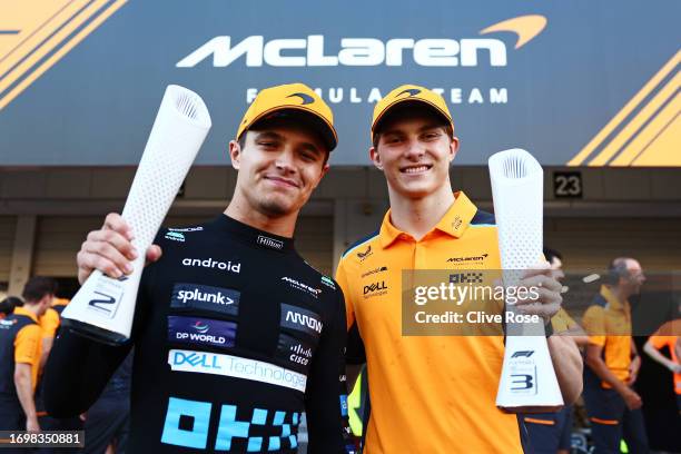 Second placed Lando Norris of Great Britain and McLaren and Third placed Oscar Piastri of Australia driving the McLaren MCL60 Mercedes pose for a...