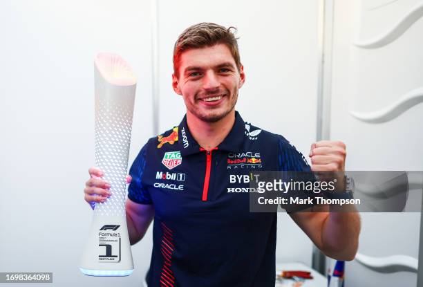 Race winner Max Verstappen of the Netherlands and Oracle Red Bull Racing poses with the trophy in his driver room after the F1 Grand Prix of Japan at...