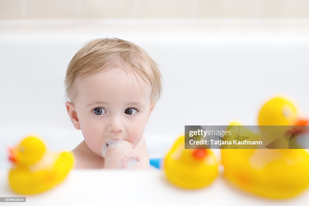 Baby sitting in bathtub