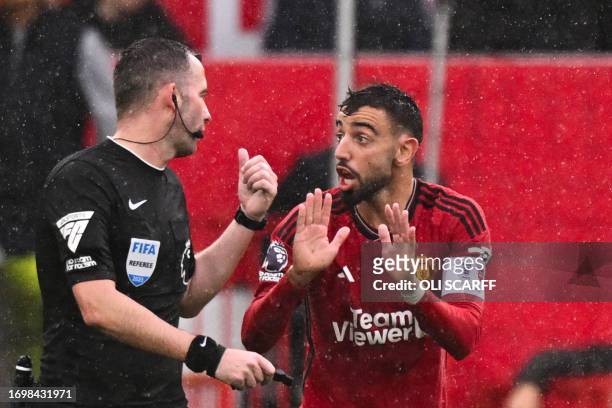 Manchester United's Portuguese midfielder Bruno Fernandes argues with the referee during the English Premier League football match between Manchester...