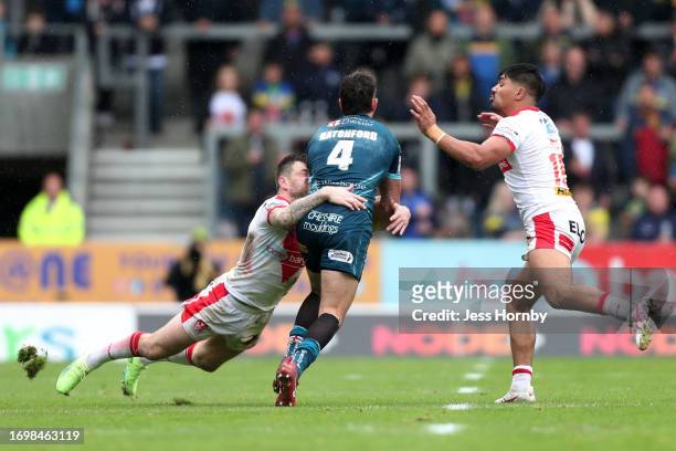 Stefan Ratchford of Warrington is challenged by Mark Percival and James Bell of St.Helens during the Betfred Super League Play-Off match between St...