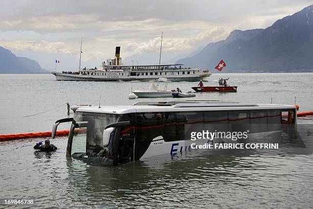 Paddle streamer of the Compagnie Generale de Navigation sur le lac Leman, commonly abbreviated to CGN, cruises on June 3, 2013 past a pullman bus...
