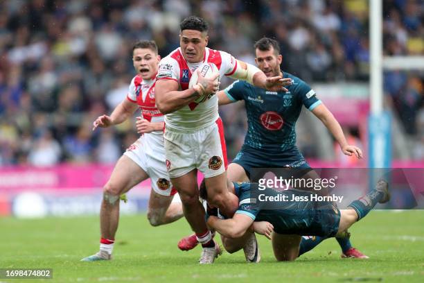 Sione Mata'utia of St.Helens is tackled by George Williams of Warrington during the Betfred Super League Play-Off match between St Helens and...