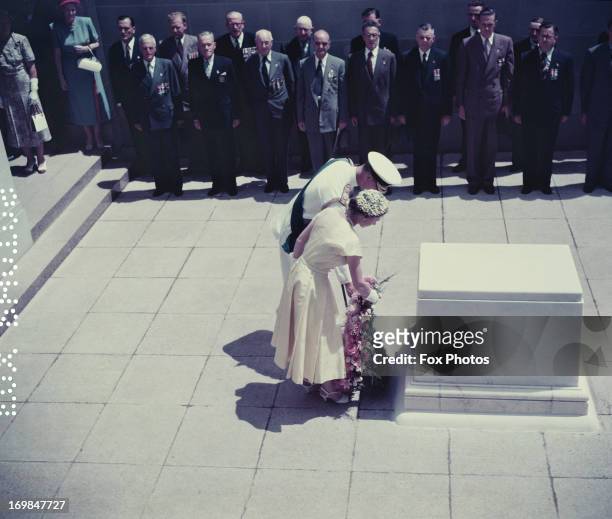 Queen Elizabeth II and Prince Philip lay a wreath on the Commemorative Stone at the Australian National War Memorial, Canberra, 1954.