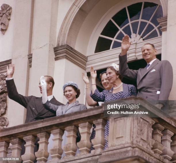 The British and Danish Royal family wave to the crowd from a balcony during the Queen's state visit to Denmark, May 1957. L-R; Prince Philip, Queen...