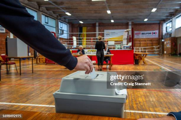 Voter casts his ballot in the run off Mayoral Elections at Horst Stief Boxing Centre voting station in Nordhausen in Thuringia on September 24, 2023...