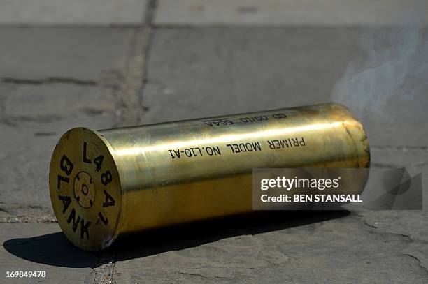 Smoke curls out of a spent blank shell casing on the floor as members of the Honourable Artillery Company , the City of London’s Territorial Army...