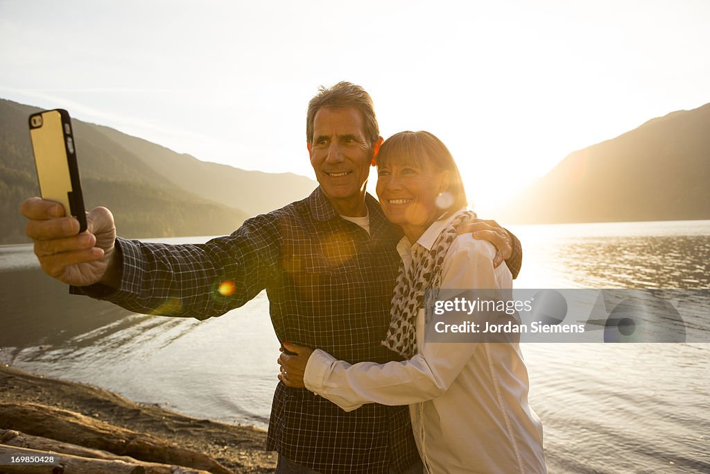 An older couple taking pictures of themselves.