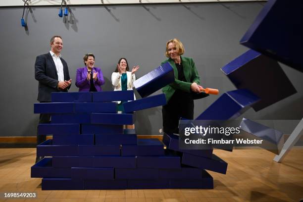 Liberal Democrat by-election winners, Richard Foord, Sarah Dyke, Sarah Green and Helen Morgan, smash through the blue wall prop during a visit to...