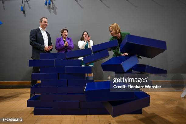Liberal Democrat by-election winners, Richard Foord, Sarah Dyke, Sarah Green and Helen Morgan, smash through the blue wall prop during a visit to...