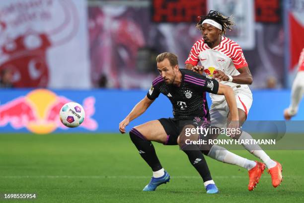 Bayern Munich's English forward Harry Kane and Leipzig's French defender Mohamed Simakan vie for the ball during the German first division Bundesliga...