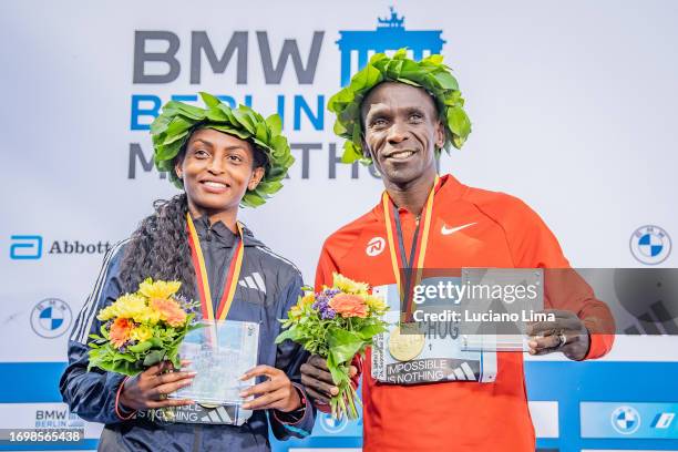 Tigist Assefa from Ethiopia and Eliud Kipchoge from Kenya celebrate their victories after the 2023 BMW Berlin-Marathon on September 24, 2023 in...