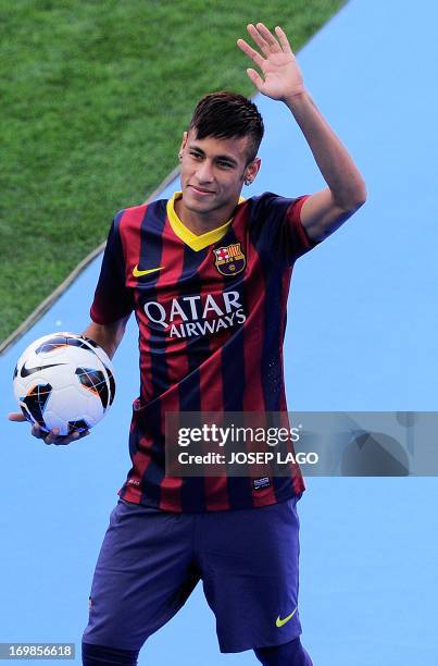 Barcelona's new player Brazilian Neymar da Silva Santos Junior waves during his presentation at Camp Nou stadium in Barcelona, on June 3, 2013....