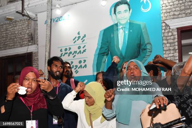 Supporters of People's National Congress party and pro-China frontrunner Mohamed Muizzu shout slogans along a street in Male on September 30 to...