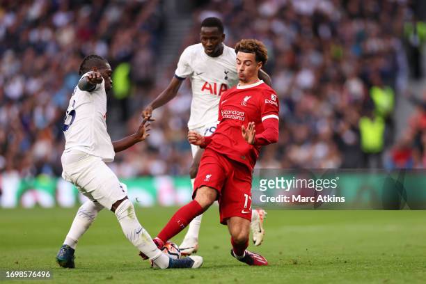 Curtis Jones of Liverpool fouls Yves Bissouma of Tottenham Hotspur before being shown a red card during the Premier League match between Tottenham...