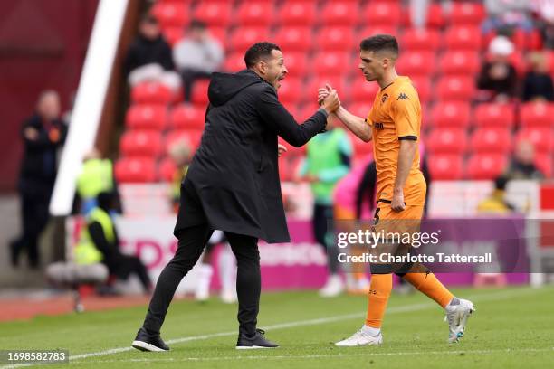 Liam Rosenior, Manager of Hull City, and Ruben Vinagre celebrate after teammate Adama Traore scores the team's second goal during the Sky Bet...