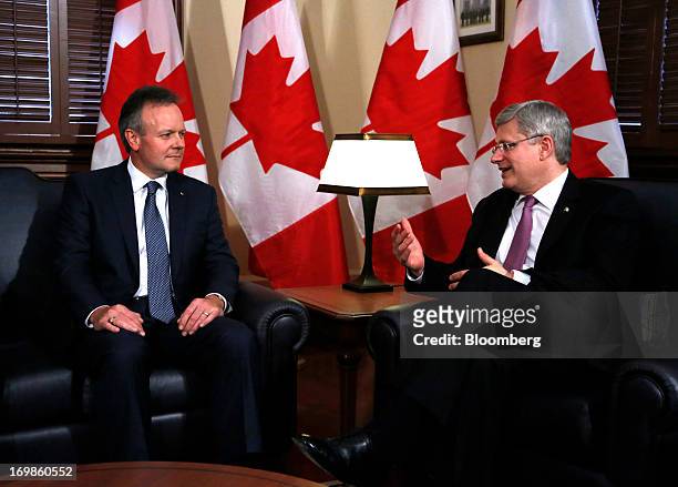 Stephen Poloz, governor of the Bank of Canada, left, speaks with by Stephen Harper, Canada's prime minister, while being welcomed into office in...