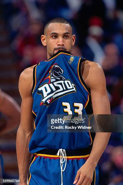 Grant Hill of the Detroit Pistons bites his jersey against the Sacramento Kings during a game played on January 22, 1997 at Arco Arena in Sacramento,...