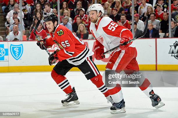 Andrew Shaw of the Chicago Blackhawks and Niklas Kronwall of the Detroit Red Wings skate up the ice in Game Seven of the Western Conference...