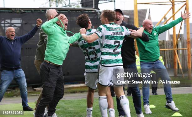 Celtic's Matt O'Riley celebrates scoring their side's second goal of the game as the Celtic fans run onto the pitch during the cinch Premiership...