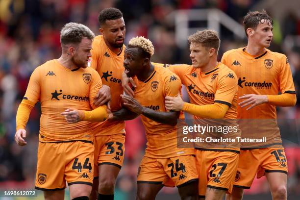 Cyrus Christie and Regan Slater of Hull City intervene as teammates Aaron Connolly and Jean Michael Seri clash whilst leaving the field at half time...