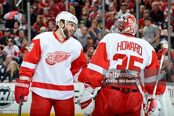 Carlo Colaiacovo of the Detroit Red Wings talks with teammate goalie Jimmy Howard in Game Seven of the Western Conference Semifinals against the...