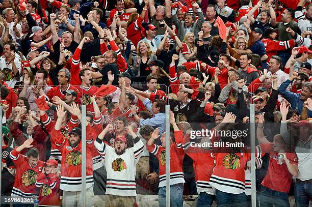 The crowd erupts in cheers after the Chicago Blackhawks scores against the Detroit Red Wings in Game Seven of the Western Conference Semifinals...