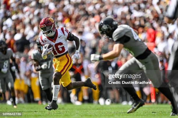 Tahj Washington of the USC Trojans runs after a catch for a touchdown against the Colorado Buffaloes in the first quarter at Folsom Field on...
