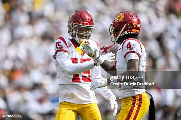 Dorian Singer of the USC Trojans celebrates with Mario Williams after a touchdown in the second quarter against the Colorado Buffaloes at Folsom...