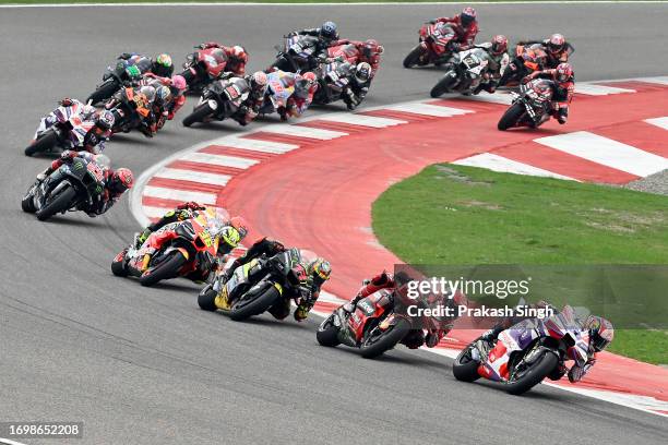 MotoGP riders compete during MotoGP race of the Indian MotoGP Grand Prix at the Buddh International Circuit in Greater Noida on the outskirts of New...