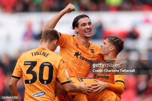 Regan Slater of Hull City celebrates with teammates after scoring the team's third goal during the Sky Bet Championship match between Stoke City and...