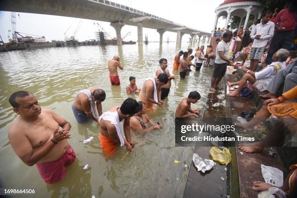 Devotees performing 'Tarpan' rituals for their ancestors at the bank of Ganga river during 'Pitra Paksh' at Gandhi Ghat on September 30, 2023 in...