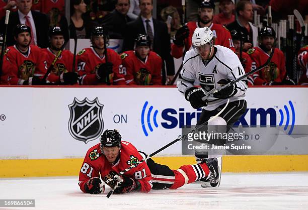 Marian Hossa of the Chicago Blackhawks falls to the ice while playing the puck from Anze Kopitar of the Los Angeles Kings in the second period of...