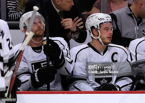 Trevor Lewis and Dustin Brown of the Los Angeles Kings watch the game from the bench in the first period of Game Two of the Western Conference Final...
