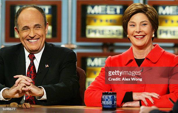 First lady Laura Bush and former New York City Mayor Rudy Giuliani smile on NBC's 'Meet the Press' at the NBC studios December 18, 2002 in...