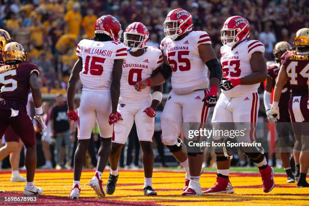 Louisiana-Lafayette Ragin Cajuns wide receiver Robert Williams celebrates with teammates after a touchdown during the college football between the...