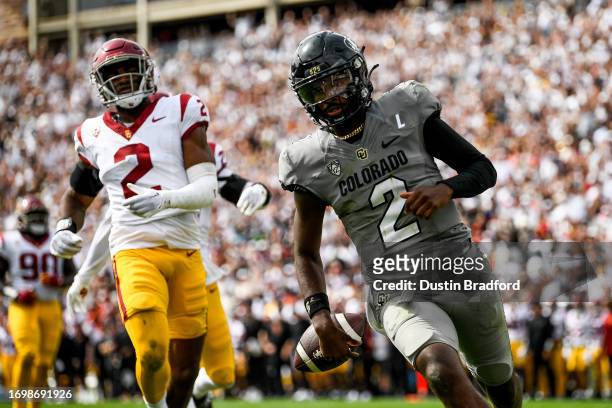 Shedeur Sanders of the Colorado Buffaloes rushes for a touchdown in the second quarter against the USC Trojans at Folsom Field on September 30, 2023...