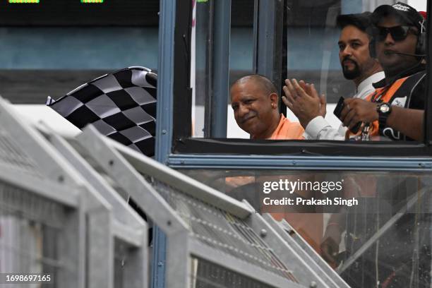 Yogi Adityanath, Uttar Pradesh Chief Minister waves the checkered flag after MotoGP race of the Indian MotoGP Grand Prix at the Buddh International...